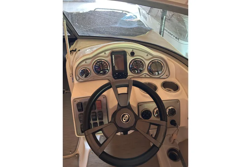 Slide: The Image of 2015 Hurricane SunDeck 2400 IO boat dashboard with steering wheel and gauges. - 1