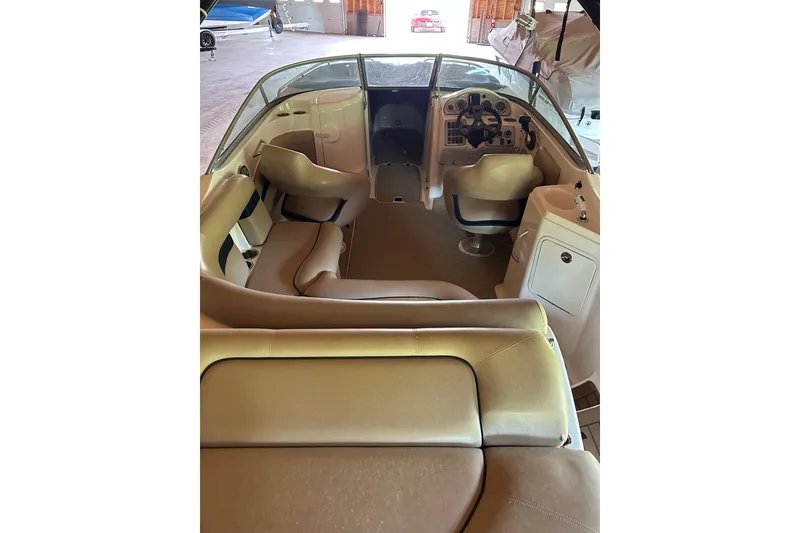 Slide: The Image of 2015 Hurricane SunDeck 2400 IO boat interior with seating and steering console. - 2