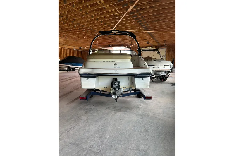 Slide: The Image of 2015 Hurricane SunDeck 2400 IO boat in a wooden storage facility. - 7