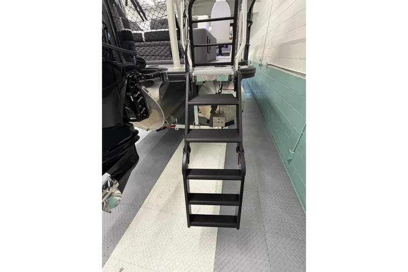 Slide: The Image of Staircase leading to South Bay 525SB2 boat interior, 2026 model, in a showroom. - 14