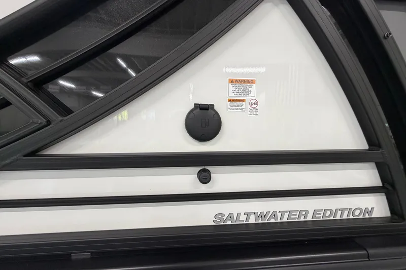 Slide: The Image of 2026 South Bay 525SB2 Saltwater Edition boat detail with warning labels and sleek design. - 17