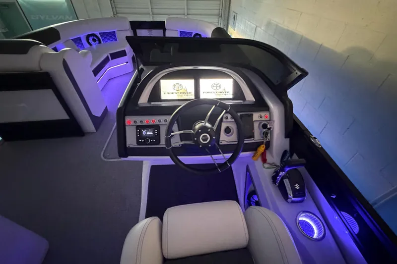 Slide: The Image of Luxurious interior of 2026 South Bay 525SB2 boat with illuminated dashboard and seating. - 23