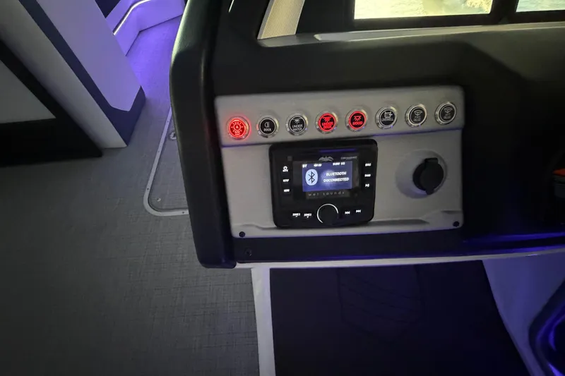 Slide: The Image of Control panel of 2026 South Bay 525SB2 boat with Bluetooth connectivity and illuminated buttons. - 24