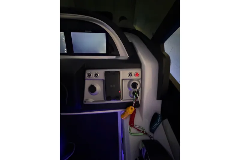 Slide: The Image of Control panel of 2026 South Bay 525SB2 boat with keys and digital display. - 26