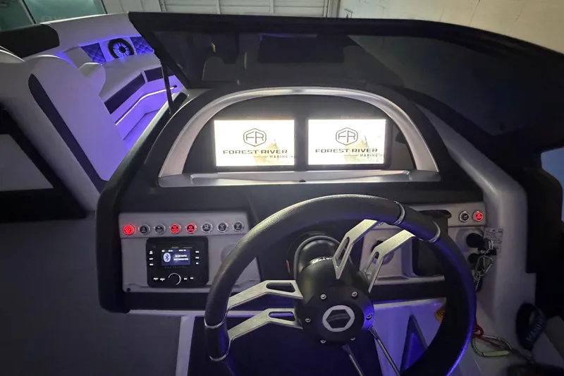 Slide: The Image of Interior dashboard of 2026 South Bay 525SB2 boat with illuminated controls and steering wheel. - 27