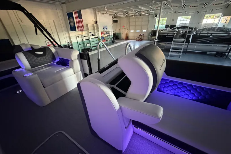Slide: The Image of Luxurious interior of 2026 South Bay 525SB2 boat with ambient purple lighting. - 32
