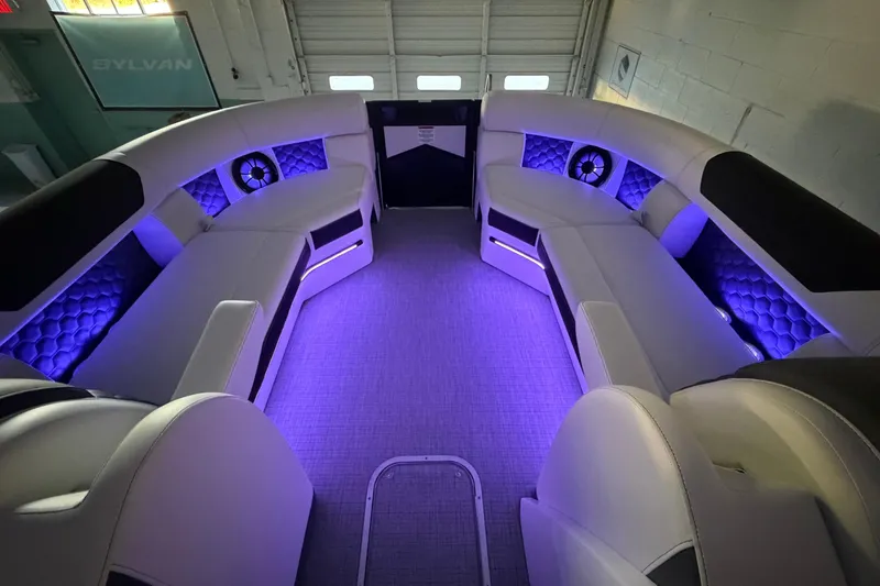 Slide: The Image of Luxurious interior of 2026 South Bay 525SB2 pontoon boat with ambient purple lighting. - 33