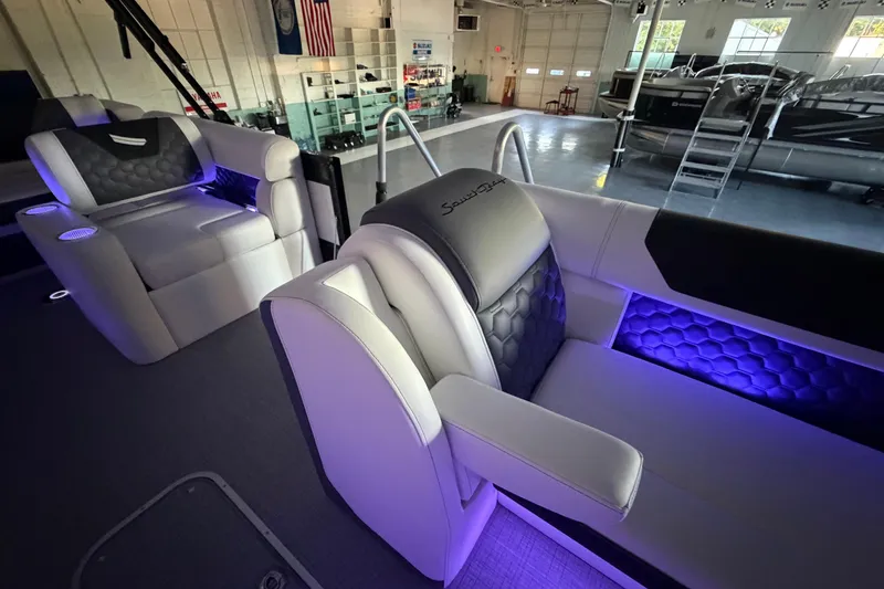 Slide: The Image of Luxurious interior of 2026 South Bay 525SB2 pontoon boat with ambient lighting. - 34