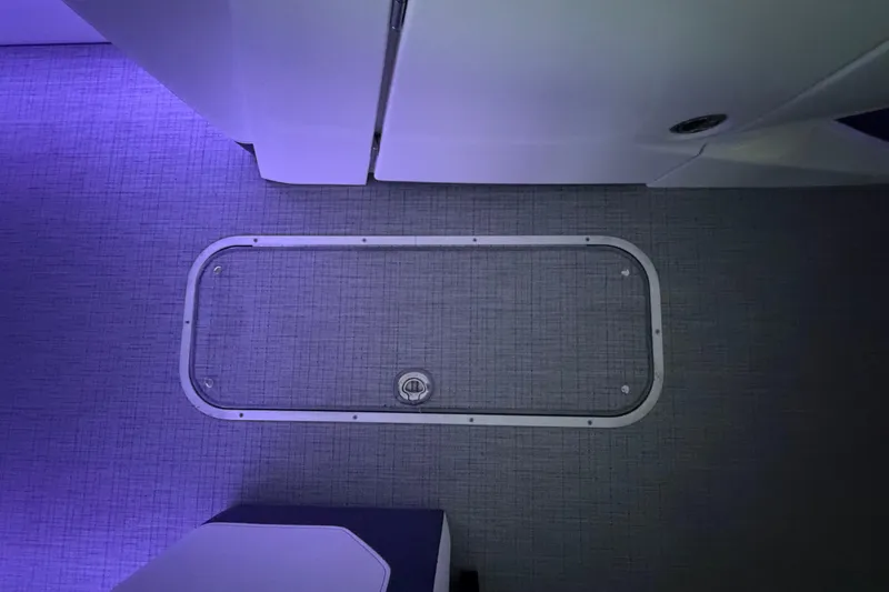 Slide: The Image of Interior view of 2026 South Bay 525SB2 boat with illuminated flooring and hatch. - 39