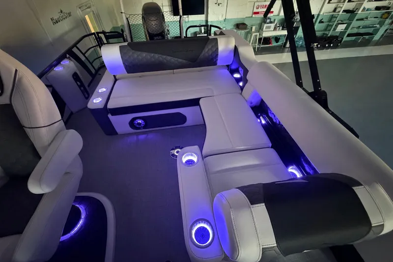 Slide: The Image of Luxurious interior of 2026 South Bay 525SB2 pontoon boat with ambient blue lighting. - 42