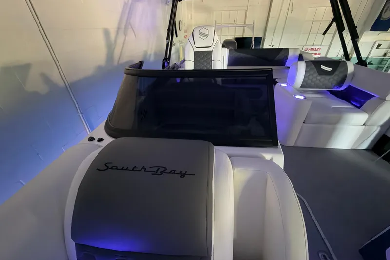 Slide: The Image of 2026 South Bay 525SB2 boat interior with modern seating and ambient lighting. - 43
