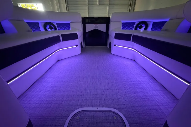 Slide: The Image of Luxurious interior of 2026 South Bay 525SB2 boat with ambient purple lighting. - 45