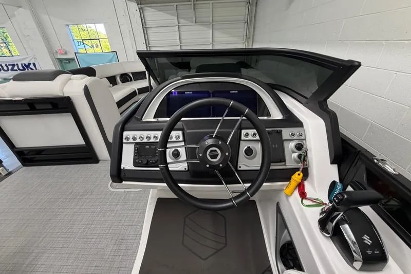Slide: The Image of Interior view of 2026 South Bay 525SB2 boat dashboard with steering wheel and controls. - 61