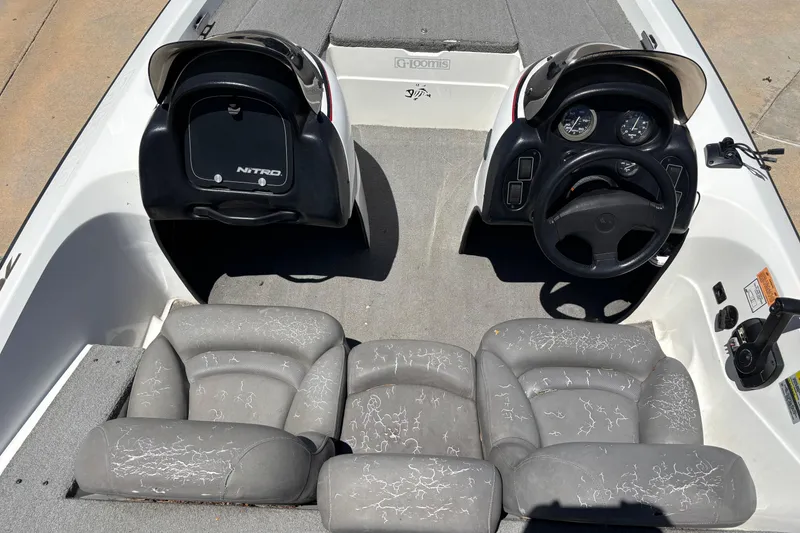 Slide: The Image of 1998 Nitro 700 LX DC boat interior with dual consoles and gray seating. - 1