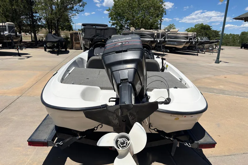 Slide: The Image of 1998 Nitro 700 LX DC boat with outboard motor on trailer, parked outdoors. - 8