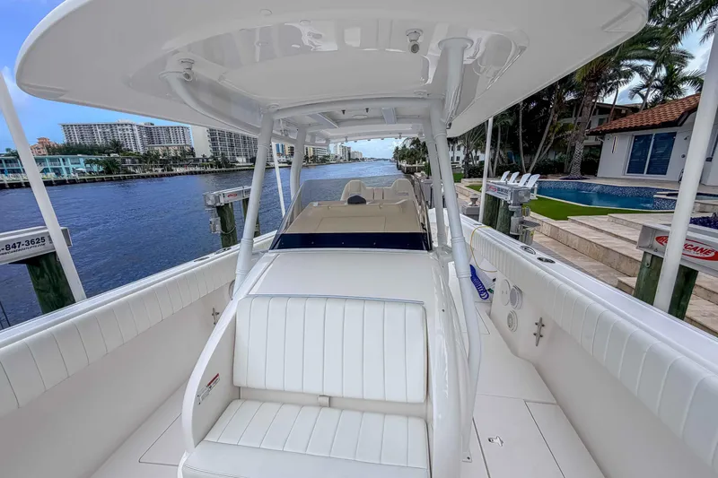 Slide: The Image of 2019 Intrepid 400 Center Console boat docked by waterfront homes. - 21