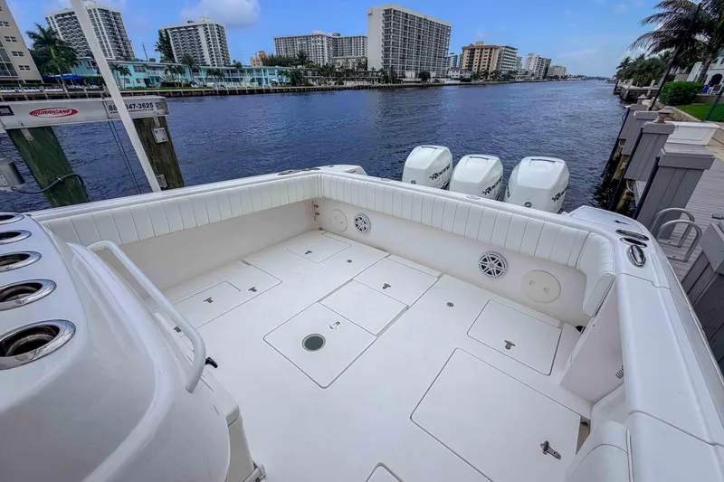 Slide: The Image of 2019 Intrepid 400 Center Console boat docked by waterfront buildings. - 30