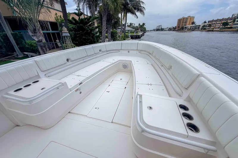 Slide: The Image of 2019 Intrepid 400 Center Console boat with spacious seating and sleek design by the water. - 37