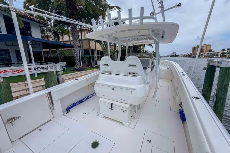Slide: The Image of 2019 Intrepid 400 Center Console boat docked by waterfront homes. - 20