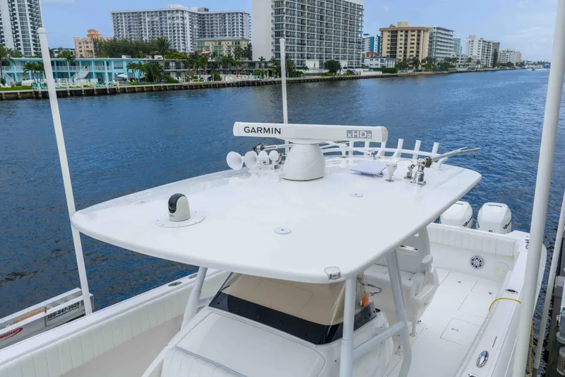 Slide: The Image of 2019 Intrepid 400 Center Console boat docked by waterfront buildings. - 15