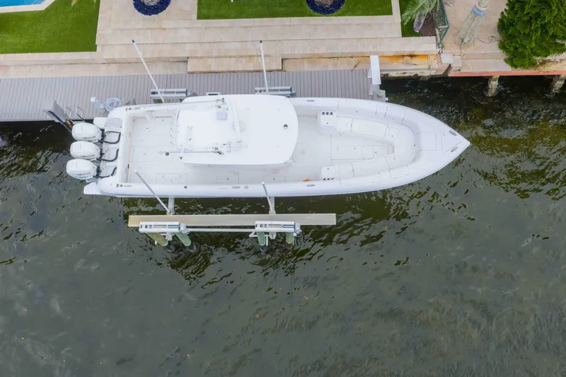 Slide: The Image of Aerial view of a 2019 Intrepid 400 Center Console boat docked by the water. - 12