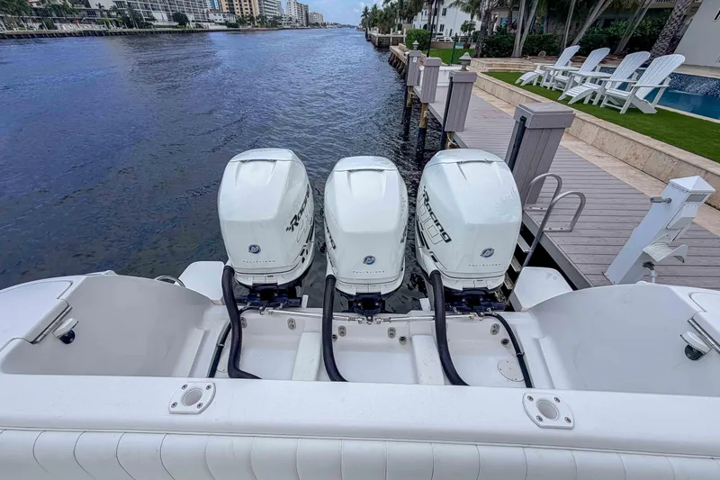 Slide: The Image of 2019 Intrepid 400 Center Console with triple outboard engines docked by waterfront. - 18