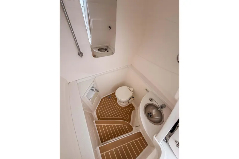 Slide: The Image of 2019 Intrepid 400 Center Console boat bathroom with sink, toilet, and wooden flooring. - 41