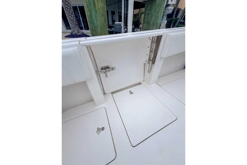 Slide: The Image of 2019 Intrepid 400 Center Console boat deck with storage compartments and secure latch. - 33