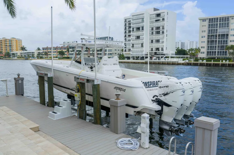 Slide: The Image of 2019 Intrepid 400 Center Console boat docked by waterfront buildings. - 11
