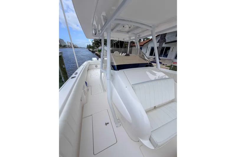 Slide: The Image of 2019 Intrepid 400 Center Console boat docked by waterfront homes. - 22