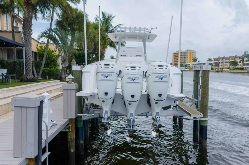 Slide: The Image of 2019 Intrepid 400 Center Console boat docked with triple outboard engines. - 7