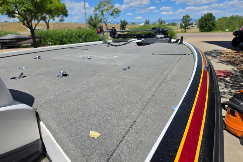 Slide: The Image of 2008 Nitro Z-9 boat deck with red and yellow trim, parked outdoors. - 6