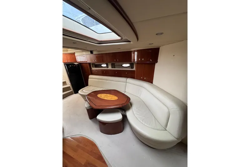 Slide: The Image of Interior of 2003 Sea Ray 550 Sundancer yacht with leather seating and wooden table. - 21