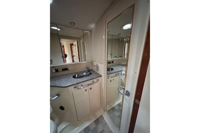 Slide: The Image of Bathroom interior of 2003 Sea Ray 550 Sundancer yacht with mirrored cabinets and sink. - 35