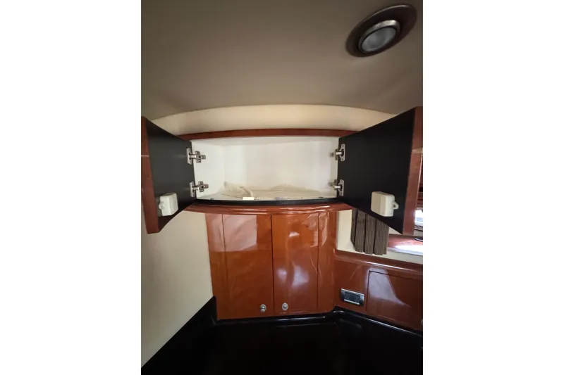 Slide: The Image of Open cabinet in 2003 Sea Ray 550 Sundancer yacht interior, showcasing storage space. - 23