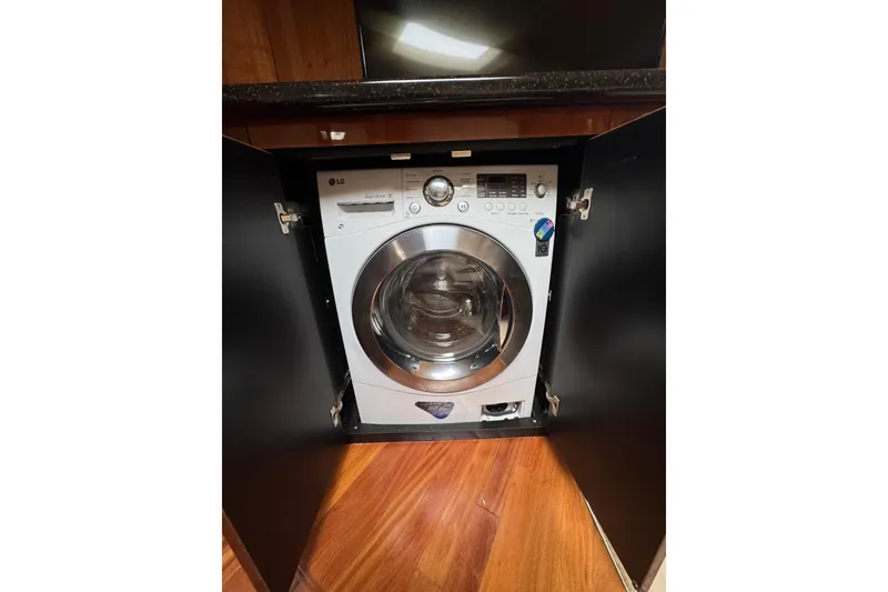 Slide: The Image of LG washer-dryer combo in a 2003 Sea Ray 550 Sundancer yacht's cabinet. - 40