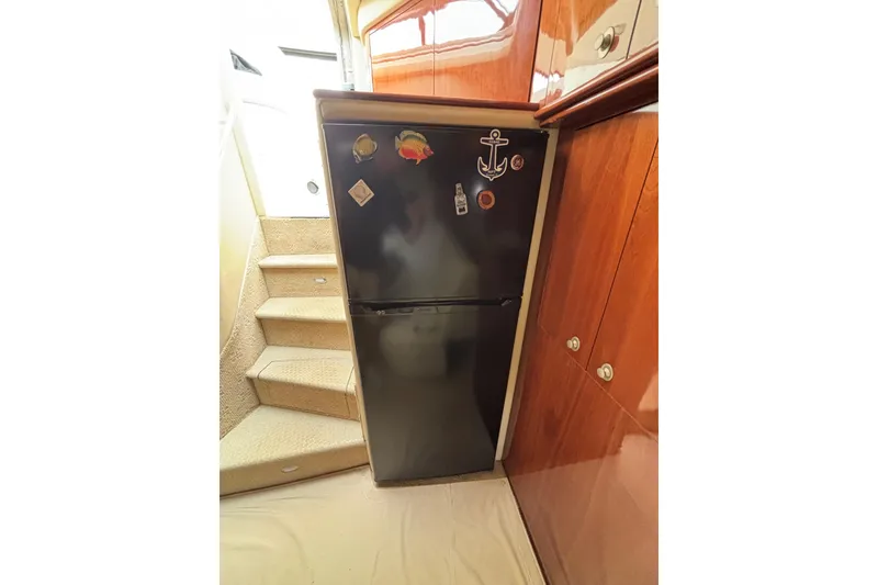 Slide: The Image of Fridge in 2003 Sea Ray 550 Sundancer yacht interior, near carpeted stairs and wooden cabinets. - 42