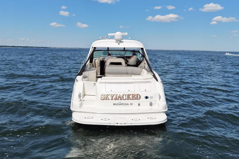 Slide: The Image of 2003 Sea Ray 550 Sundancer yacht on open water under clear blue sky. - 6