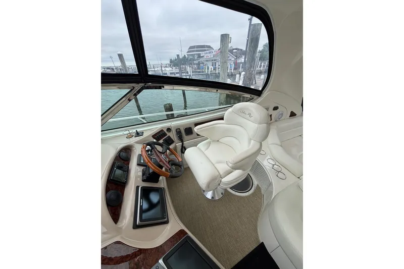 Slide: The Image of Helm of 2003 Sea Ray 550 Sundancer with leather captain's chair and wooden steering wheel. - 11
