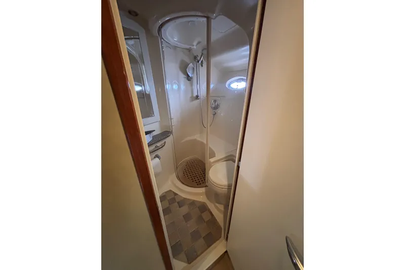 Slide: The Image of Bathroom interior of 2003 Sea Ray 550 Sundancer yacht, featuring shower and toilet. - 36