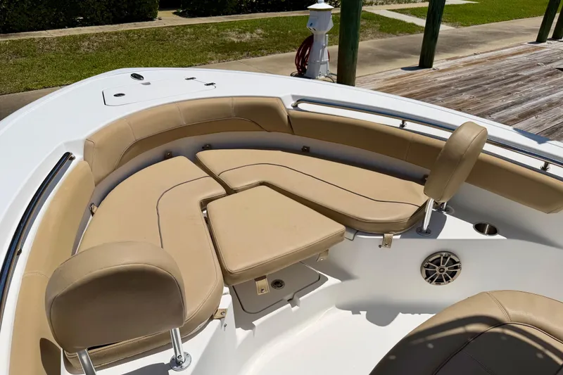 Slide: The Image of 2016 Sportsman Heritage 211 Center Console boat with tan cushioned seating area. - 10