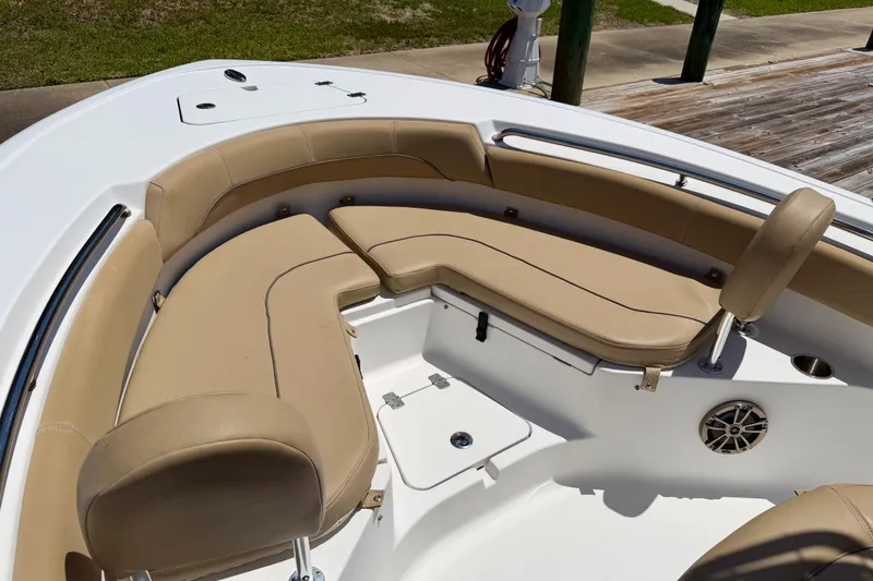 Slide: The Image of 2016 Sportsman Heritage 211 Center Console boat with tan cushioned seating area. - 11