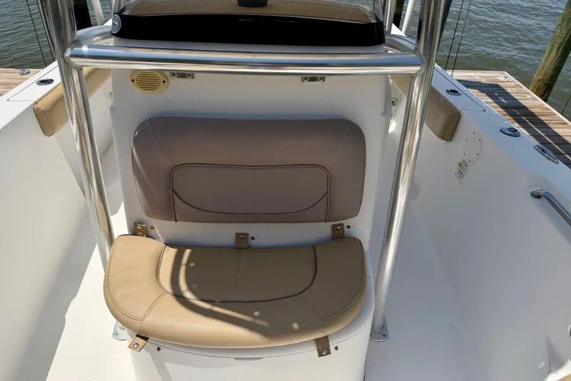 Slide: The Image of 2016 Sportsman Heritage 211 Center Console boat seating area with beige cushions. - 12
