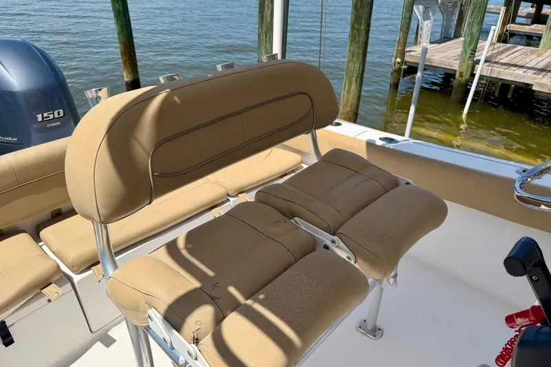 Slide: The Image of 2016 Sportsman Heritage 211 Center Console boat interior with tan seating and Yamaha 150 engine. - 14
