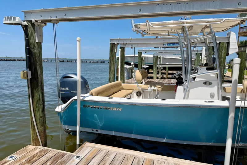 Slide: The Image of 2016 Sportsman Heritage 211 Center Console boat docked by the water. - 3