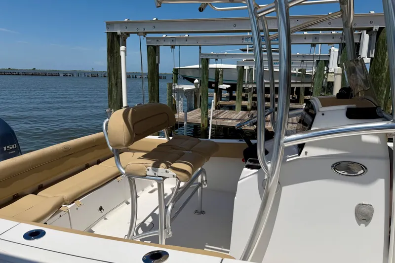 Slide: The Image of 2016 Sportsman Heritage 211 Center Console boat docked, featuring tan seating and stainless steel railings. - 5