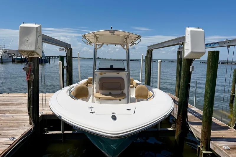 Slide: The Image of 2016 Sportsman Heritage 211 Center Console boat docked on a sunny day. - 7