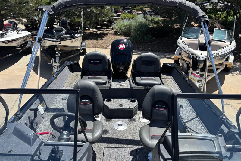 Slide: The Image of 2025 Tracker Pro Guide V-175 Combo boat interior with seating and steering wheel. - 3
