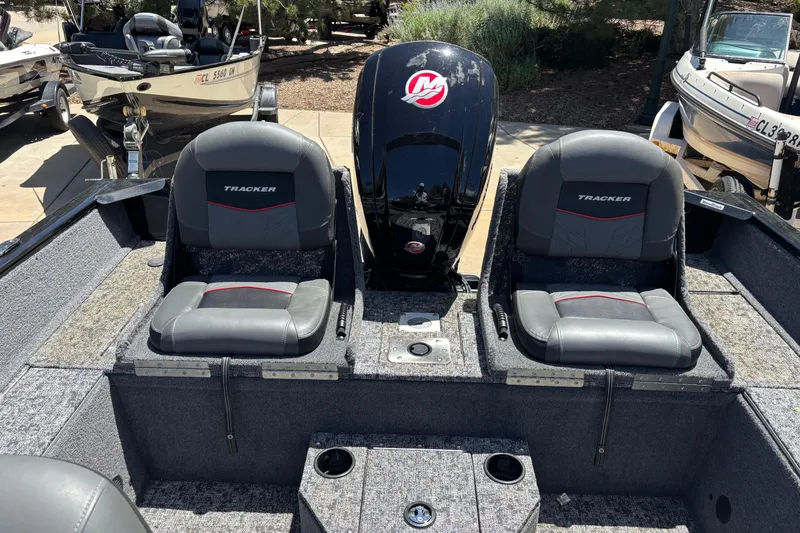 Slide: The Image of 2025 Tracker Pro Guide V-175 Combo boat interior with dual seats and motor. - 4