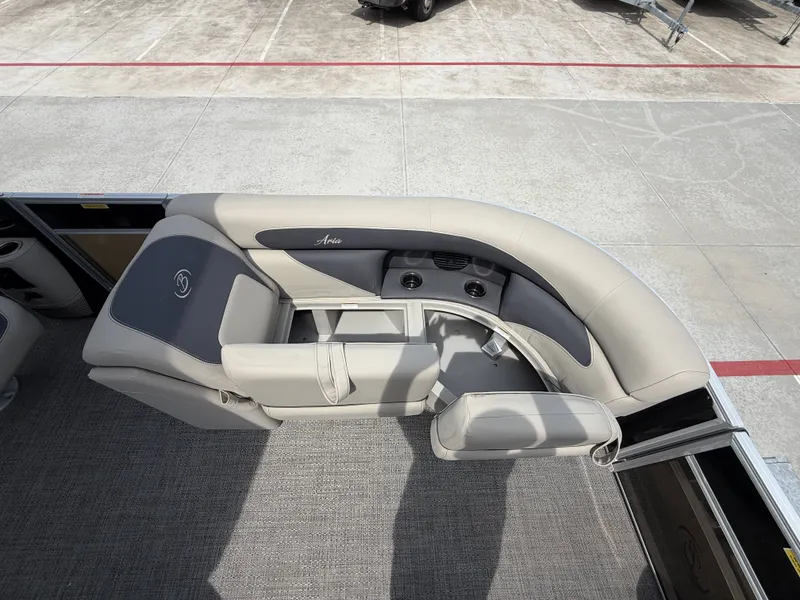 Slide: The Image of The image shows the sleek gray and cream seating area of a Barletta A20UC pontoon boat. - 14